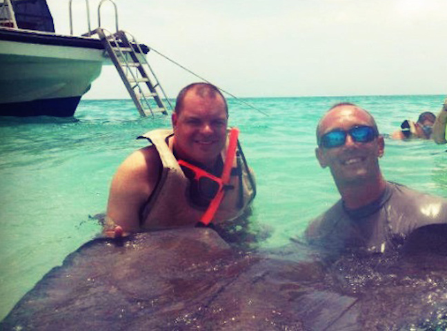 Tommy Schroader petting a giant stingray